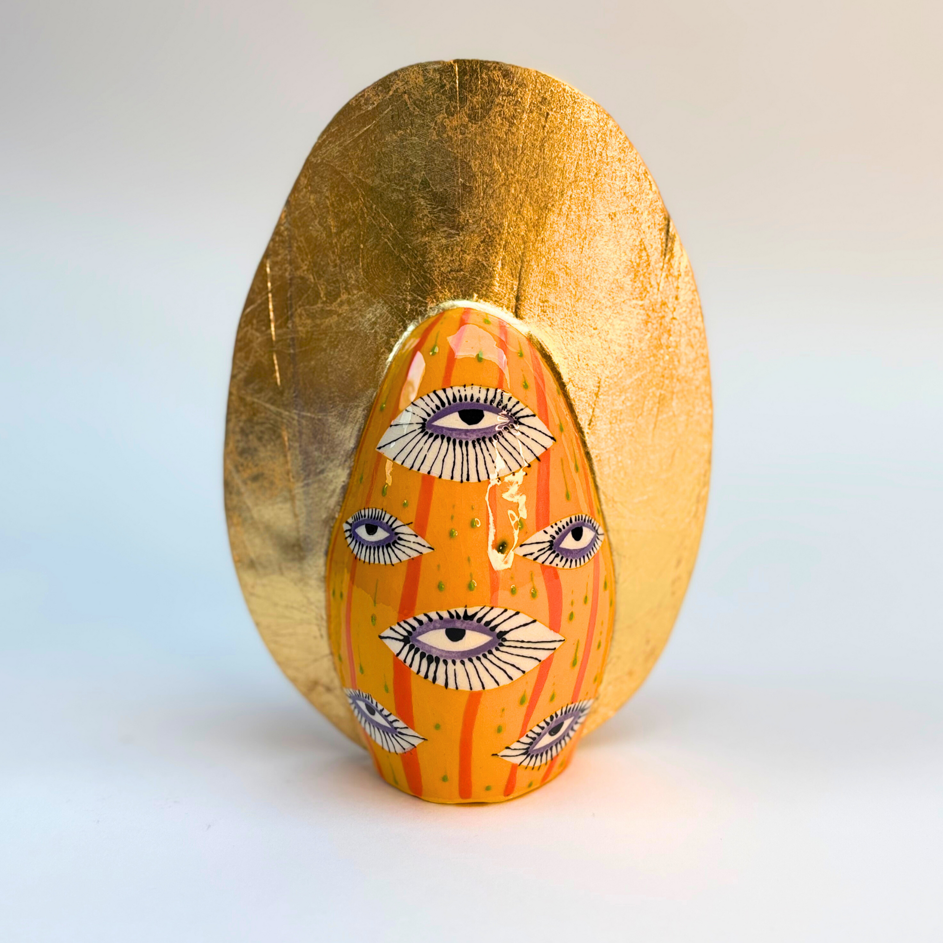 back view of 16cm ceramic goddess with eye design on body with a gold crown