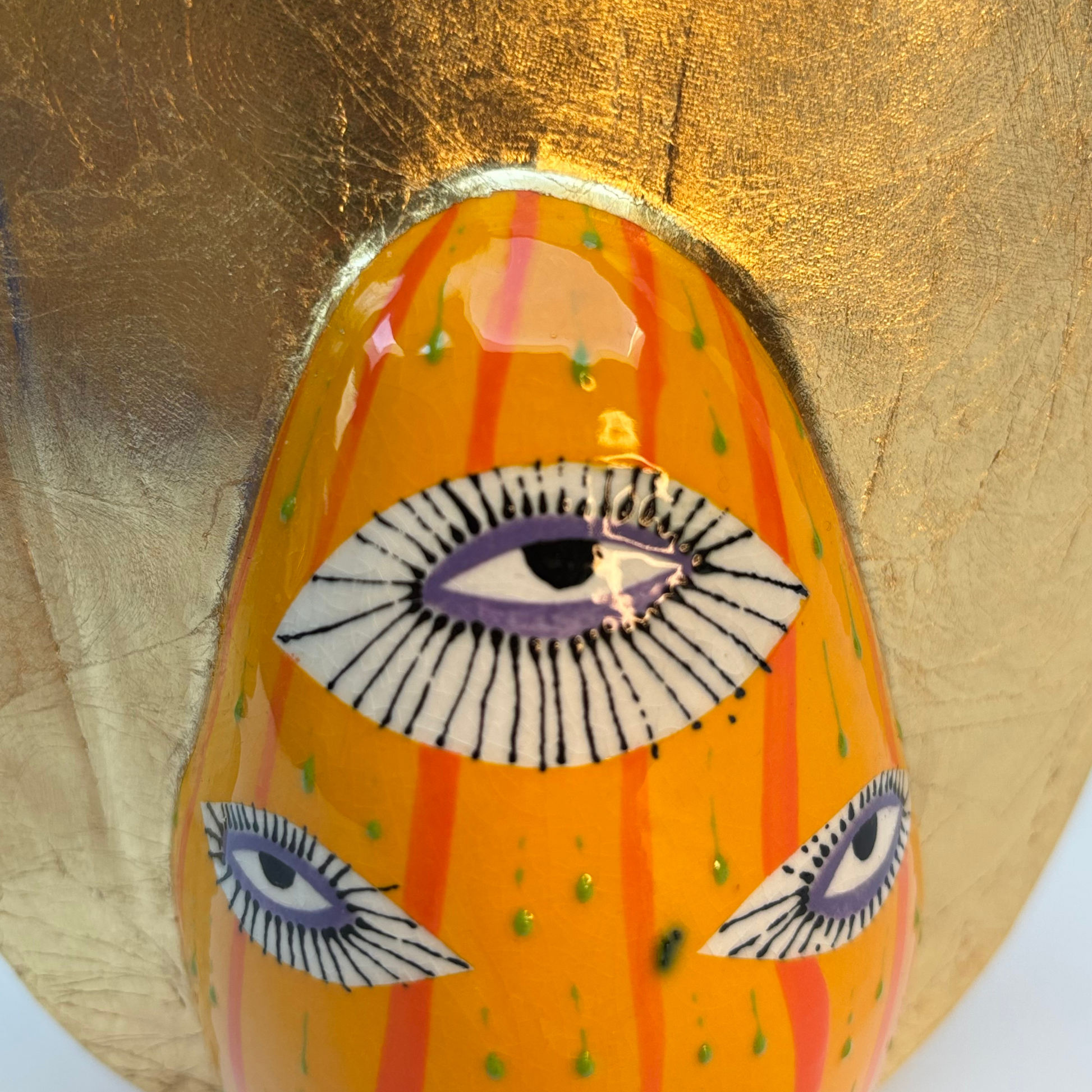 close up of back of gold crown and goddess eye design